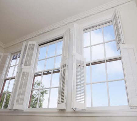 Sky seen through windows with louver shutters