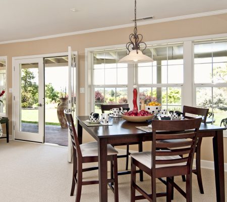 Dinning area with large window views, nice wooden table with table settings, french doors